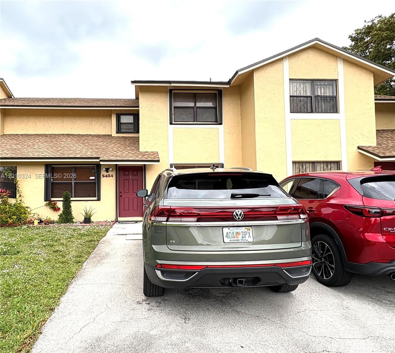 5424 Gate Lake Road, Unit 5424 Tamarac, FL 33319 - Photo 6 of 10 a front view of a house with a garden