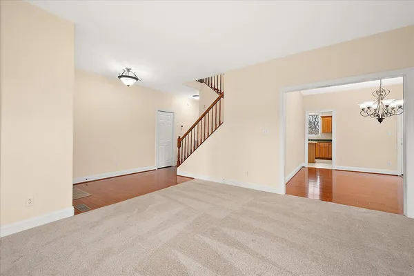 a spacious bathroom with a granite countertop sink a toilet and a large mirror