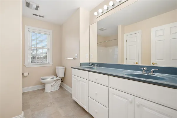 a kitchen with stainless steel appliances kitchen island granite countertop a sink cabinets and window