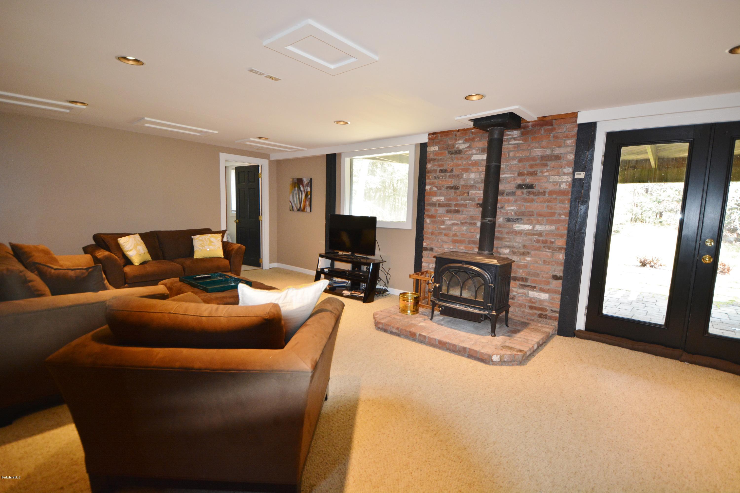 262 North Beech Plain Road Sandisfield, MA 01255 - Photo 15 of 23 a living room with furniture a flat screen tv and a fireplace