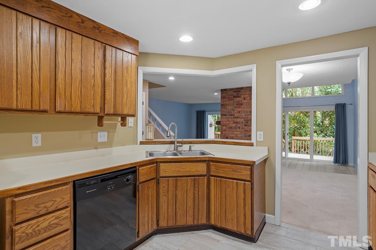 4341 Sunscape Lane Raleigh, NC 27613 - Photo 11 of 32 a kitchen with a sink cabinets and wooden floor