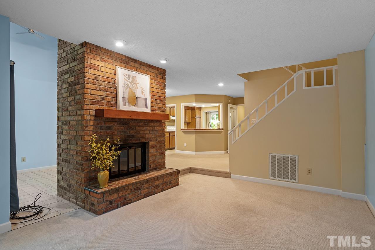 4341 Sunscape Lane Raleigh, NC 27613 - Photo 15 of 32 a living room with furniture and a fireplace