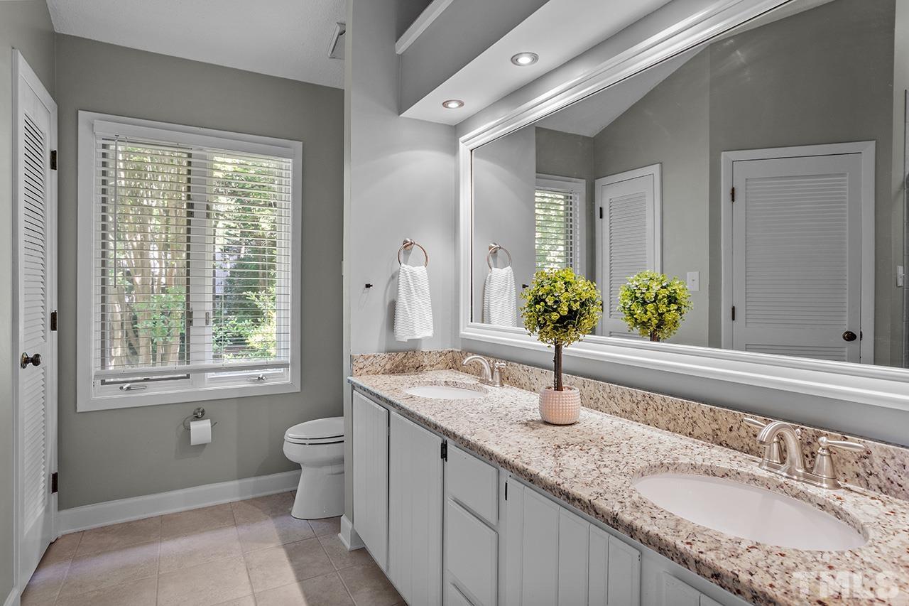 4341 Sunscape Lane Raleigh, NC 27613 - Photo 25 of 32 a bathroom with a granite countertop sink and a mirror