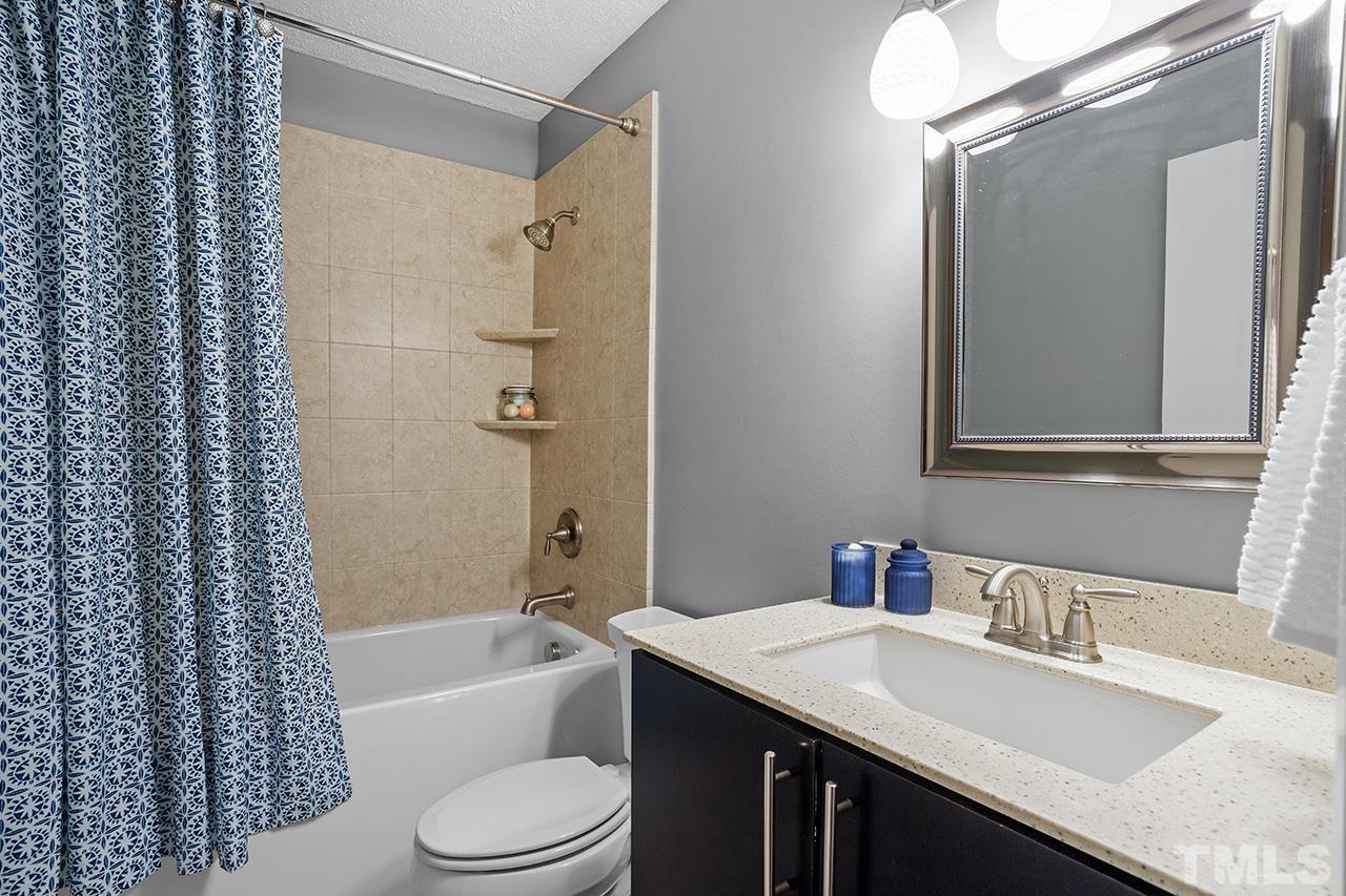 4341 Sunscape Lane Raleigh, NC 27613 - Photo 28 of 32 a bathroom with a granite countertop sink toilet and shower