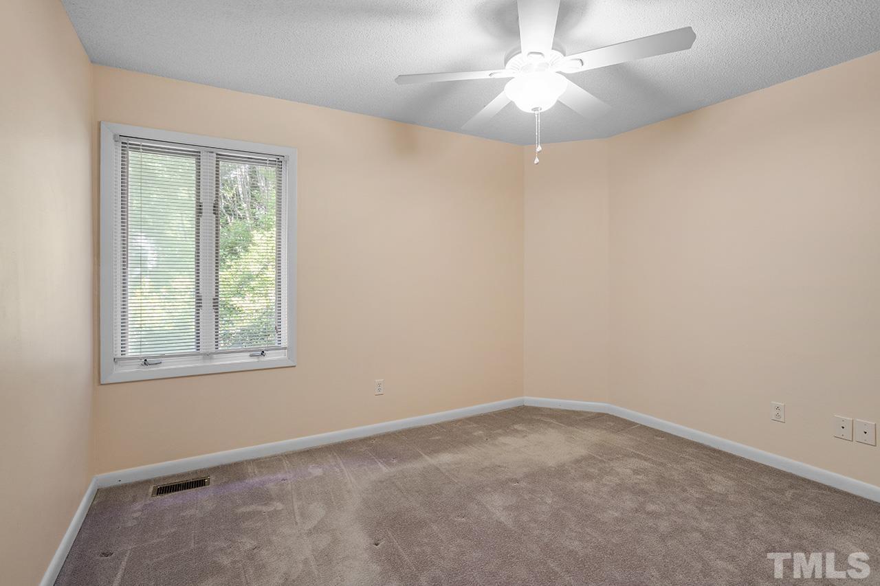 4341 Sunscape Lane Raleigh, NC 27613 - Photo 29 of 32 an empty room with a window and a fan