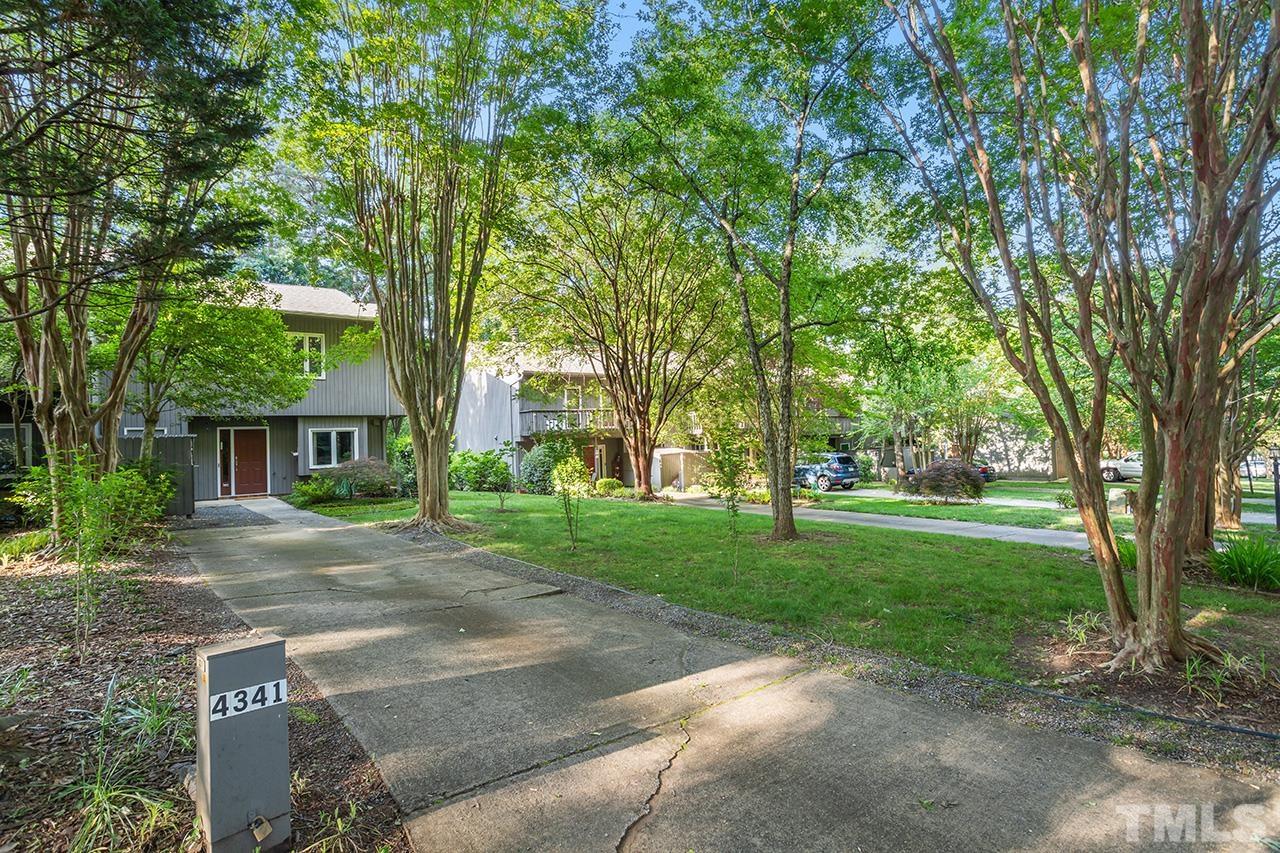 4341 Sunscape Lane Raleigh, NC 27613 - Photo 3 of 32 a view of a yard with plants and trees