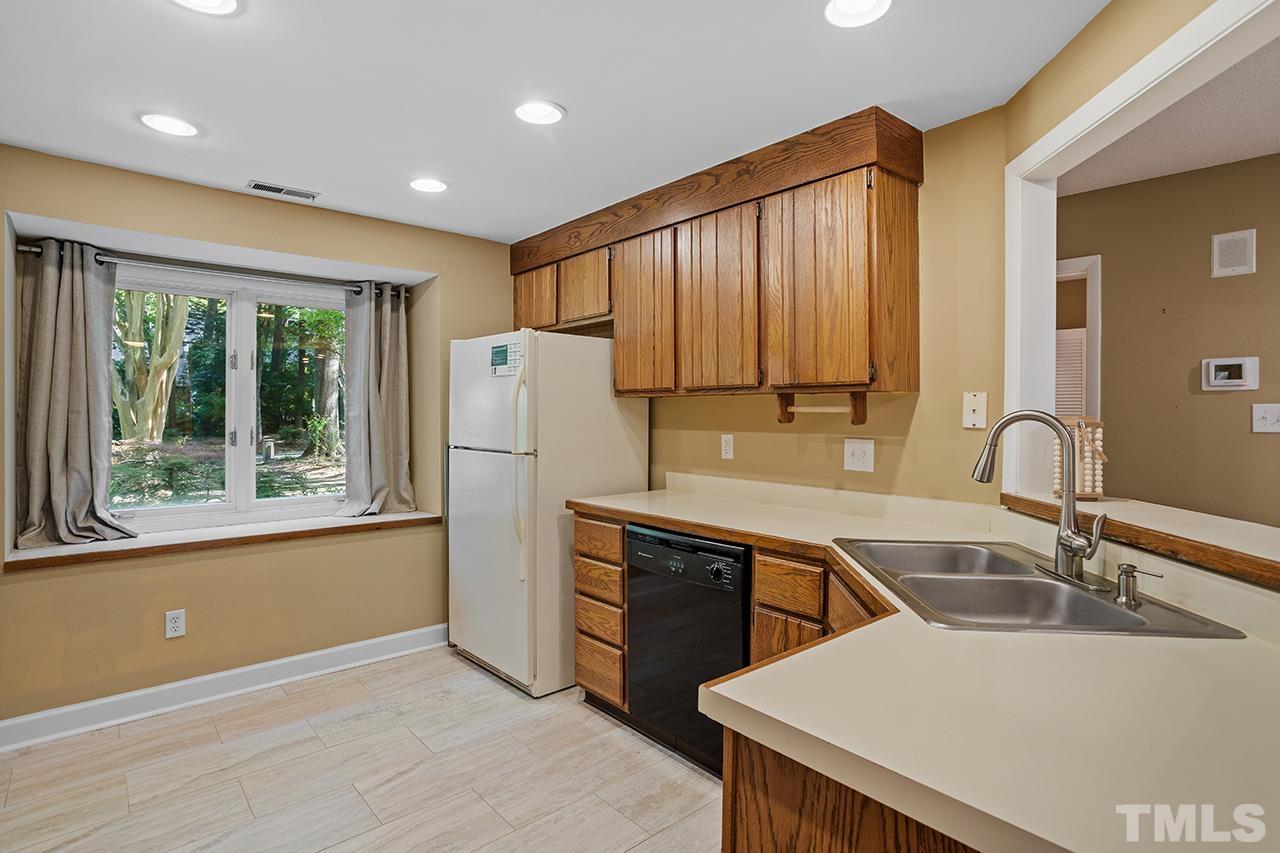 4341 Sunscape Lane Raleigh, NC 27613 - Photo 10 of 32 a kitchen that has a sink a stove and a refrigerator