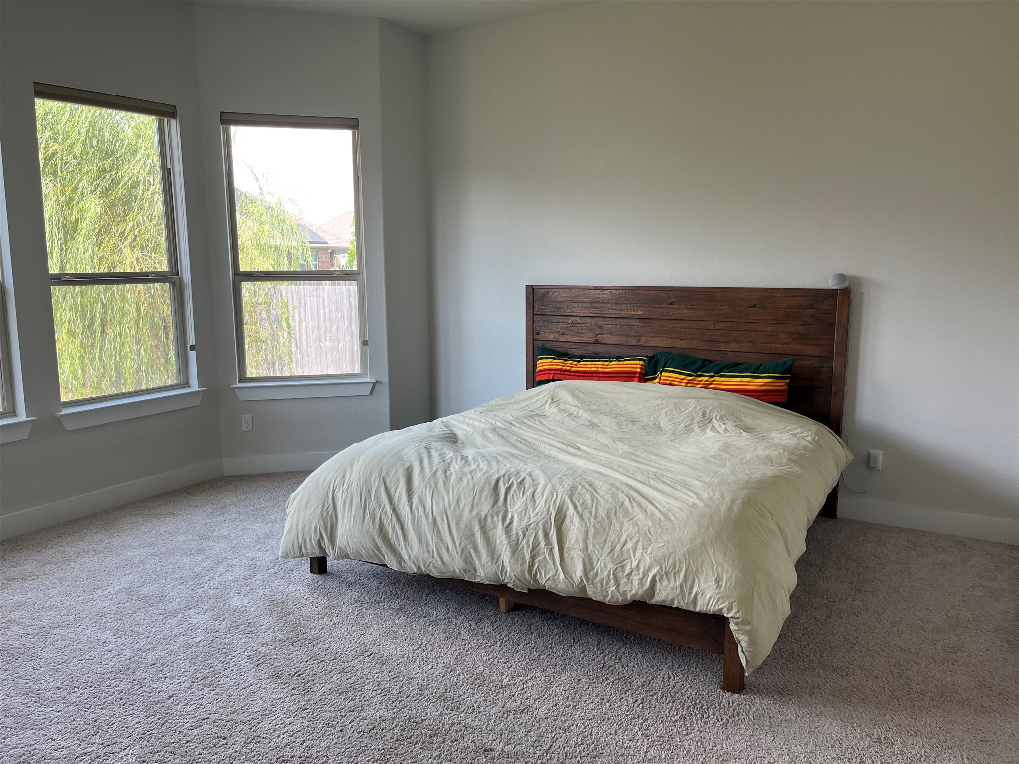 4420 Kings Cross Road Pflugerville, TX 78660 - Photo 7 of 13 Well-lit sleeping quarters with bay windows and soft carpeting create a tranquil retreat.