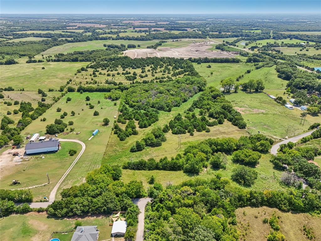 an aerial view of a houses with a yard