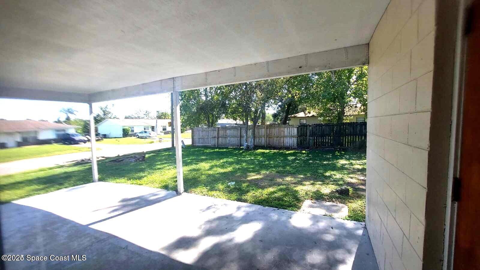 2441 Uranus Drive Cocoa, FL 32926 - Photo 8 of 8 a view of a yard with porch and wooden fence