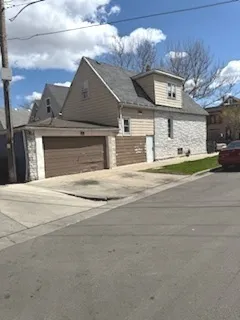 a view of a house with a yard and garage