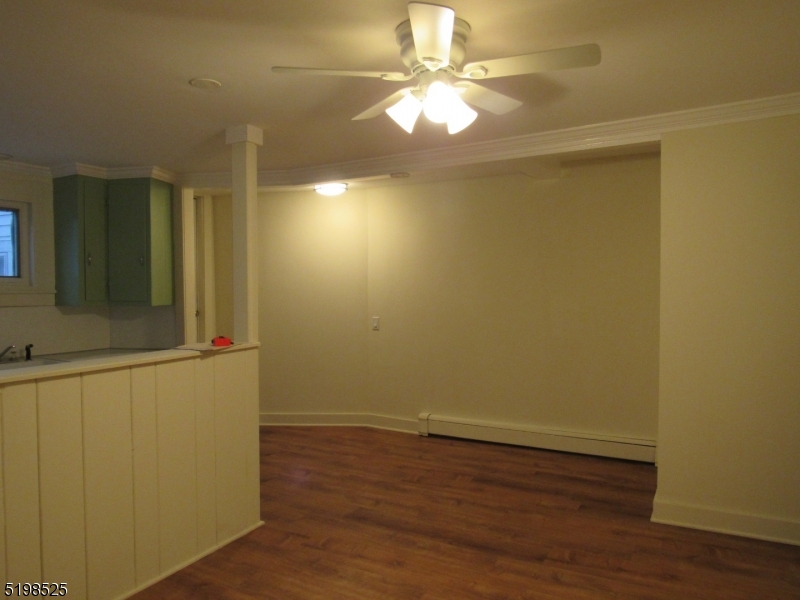 49 Bridge Street Frenchtown, NJ 08825 - Photo 5 of 12 an empty room with wooden floor and fan