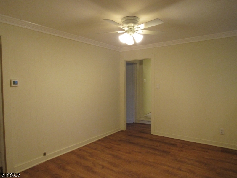 49 Bridge Street Frenchtown, NJ 08825 - Photo 7 of 12 an empty room with wooden floor and a window