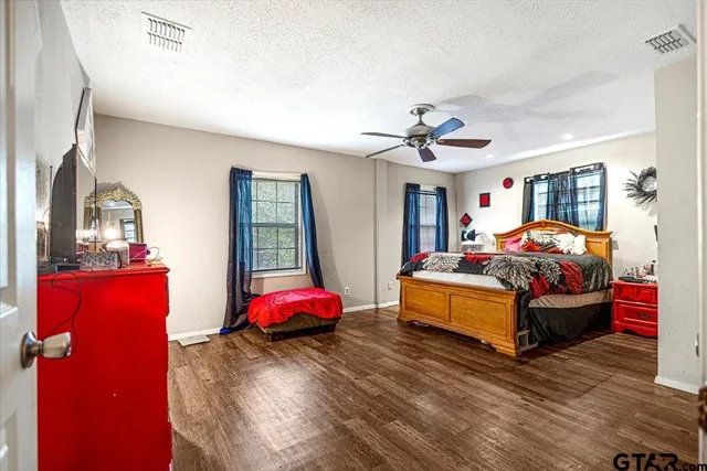 a bathroom with a toilet and a shower curtain