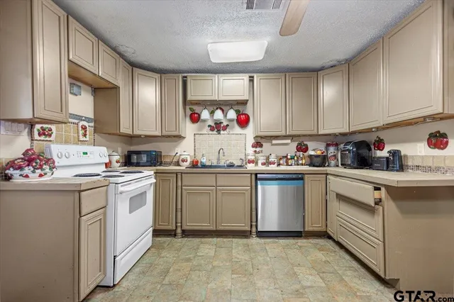 a kitchen with refrigerator and cabinets