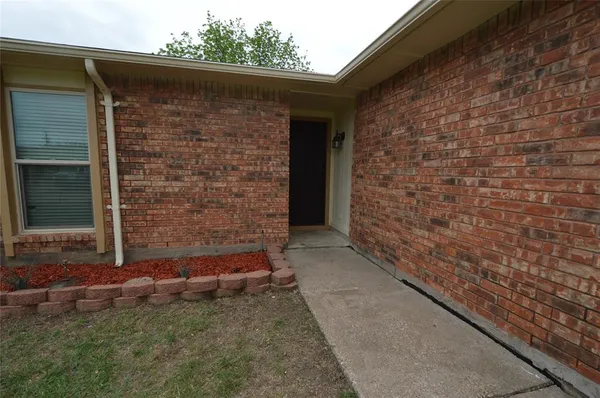 a view of front door of a house with a yard