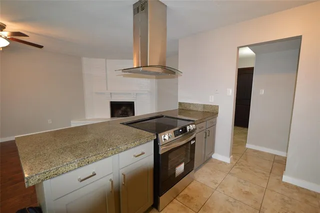 a kitchen with granite countertop a stove and a sink