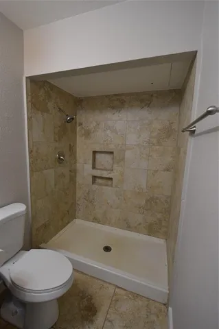a bathroom with a shower and a toilet