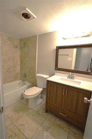 a bathroom with a toilet a sink and bathtub