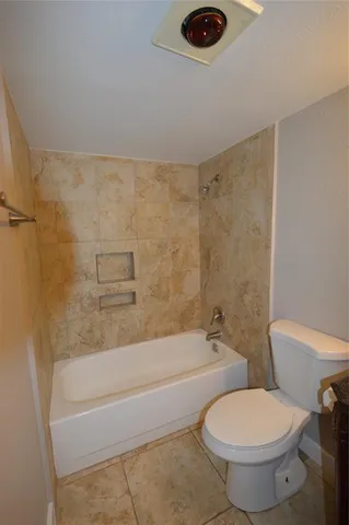 a bathroom with a toilet and a bathtub