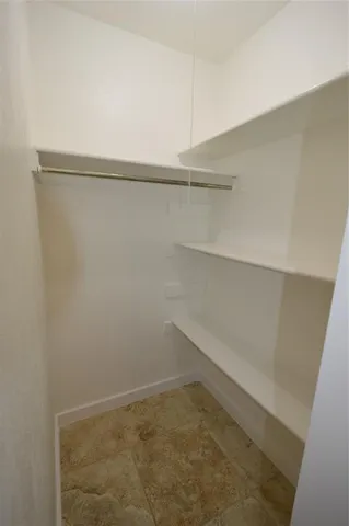 a view of a room with shelf on the wall