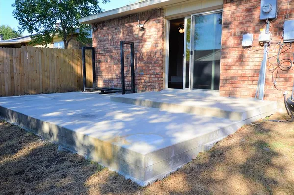 a view of a house with a wooden fence