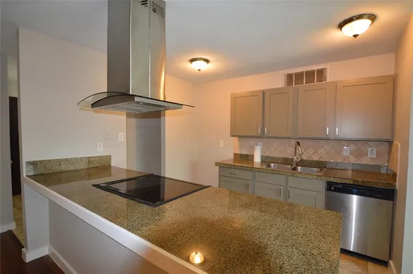 a kitchen with stainless steel appliances granite countertop a sink a stove and a refrigerator