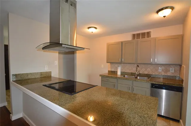 a kitchen with stainless steel appliances granite countertop a sink a stove and a refrigerator