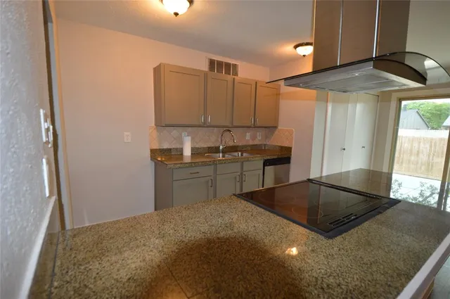 a kitchen with stainless steel appliances granite countertop a sink stove and cabinets