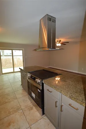 a kitchen with a stove and a mirror