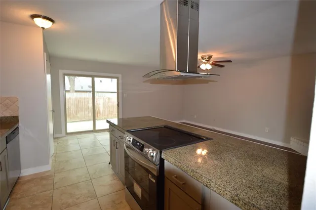 a kitchen with a sink a stove and a window