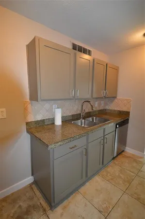 a kitchen with a sink and cabinets