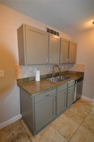 a kitchen with a sink and cabinets