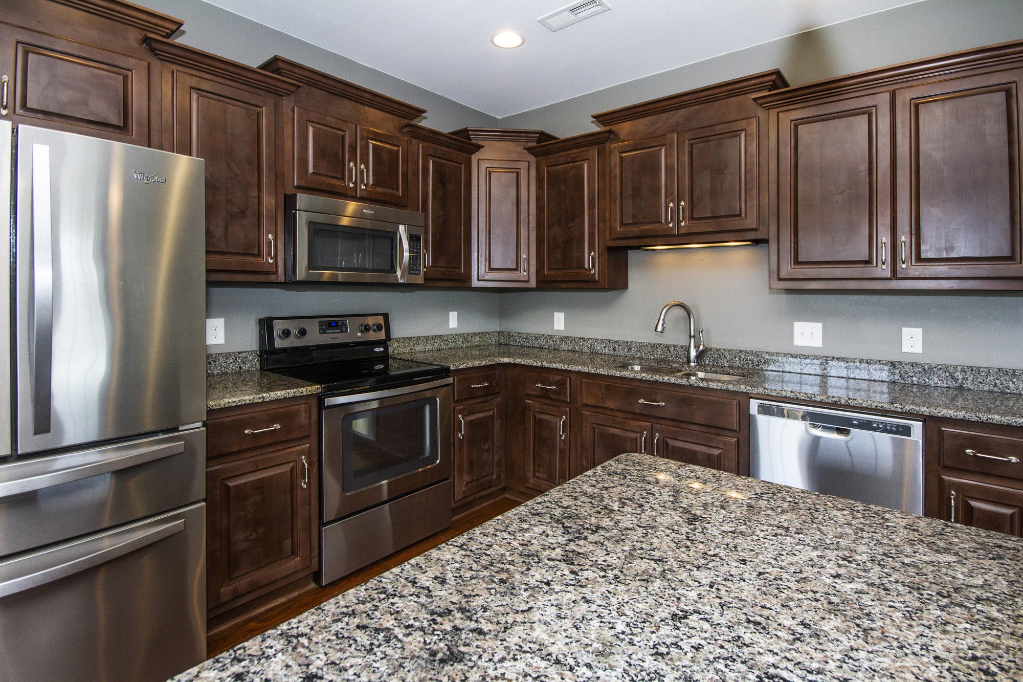 7480 Dry Valley Road Loudon, TN 37774 - Photo 14 of 27 a kitchen with granite countertop stainless steel appliances and wooden cabinets