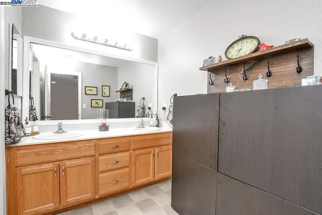 a kitchen with stainless steel appliances granite countertop a sink and a refrigerator