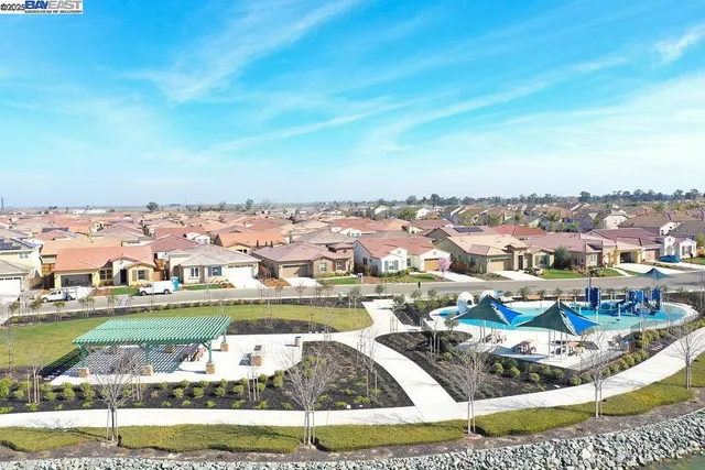 a swimming pool with outdoor seating and yard