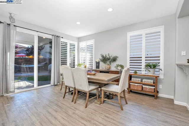 a dining room with furniture and wooden floor