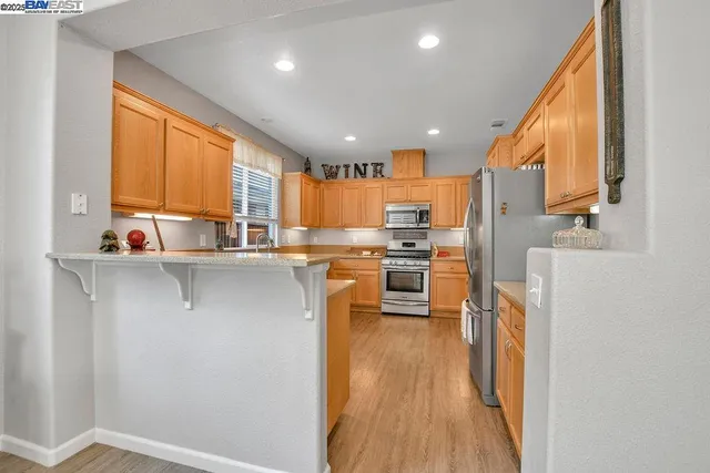 a kitchen with stainless steel appliances a refrigerator and a stove top oven