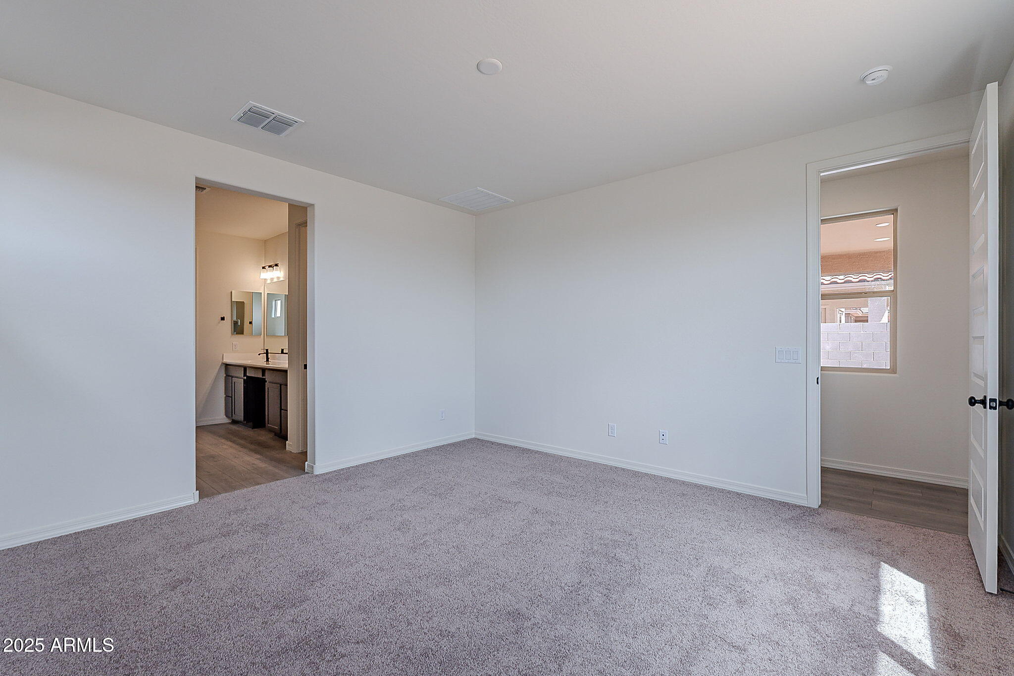 40025 Bunker Drive Maricopa, AZ 85138 - Photo 13 of 18 an empty room with windows and cabinet