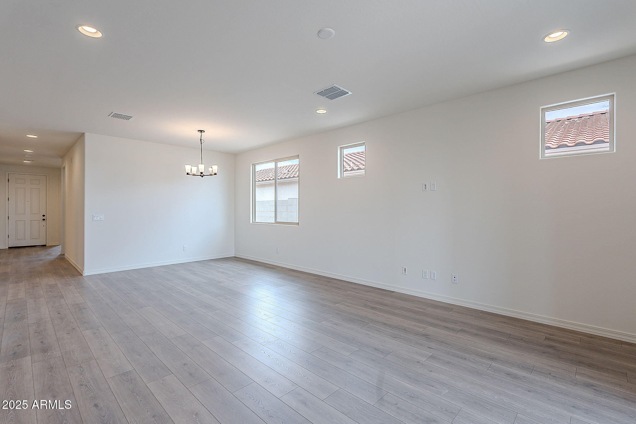 40025 Bunker Drive Maricopa, AZ 85138 - Photo 18 of 18 an empty room with wooden floor and windows
