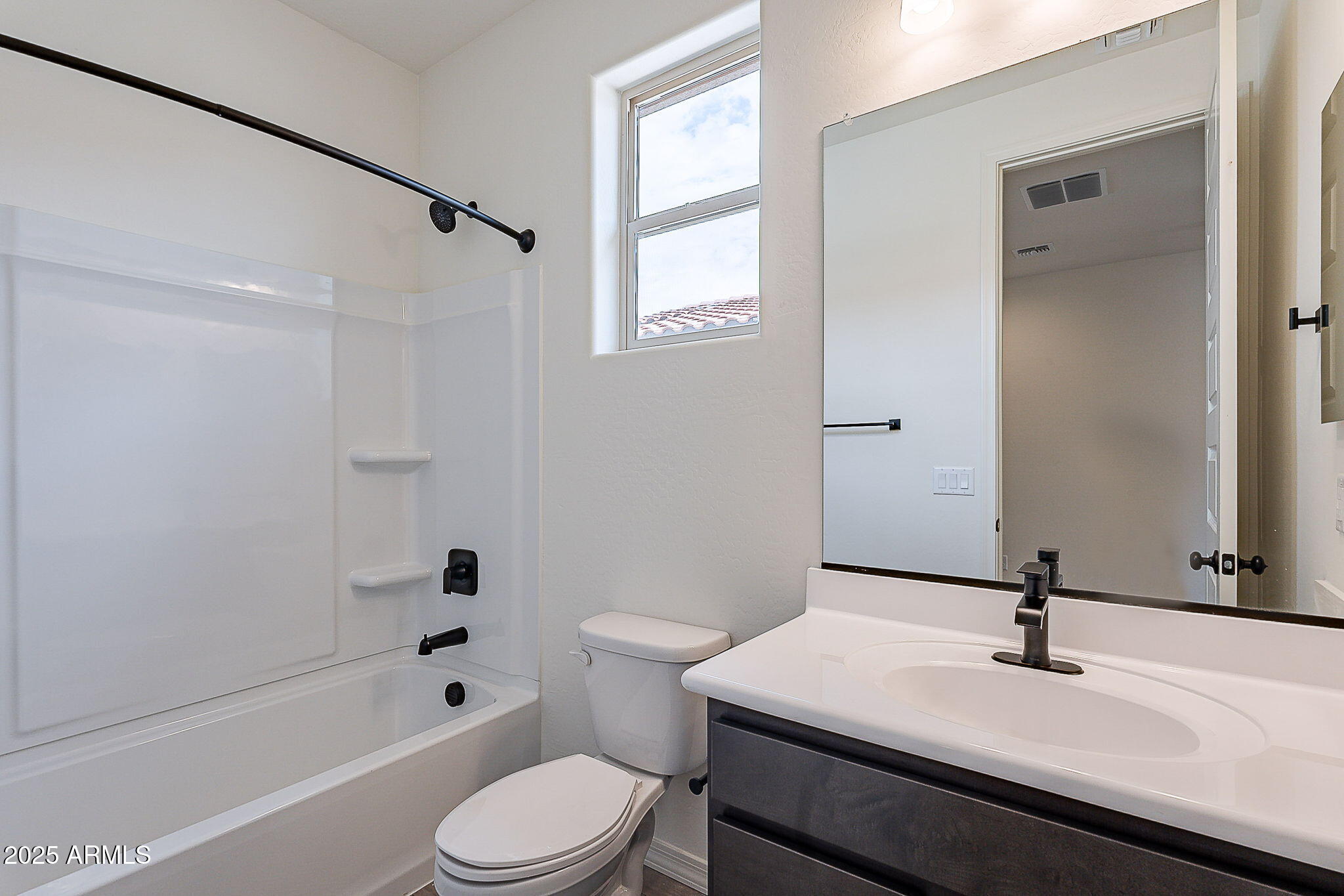40025 Bunker Drive Maricopa, AZ 85138 - Photo 5 of 18 a bathroom with a sink a toilet and a bathtub