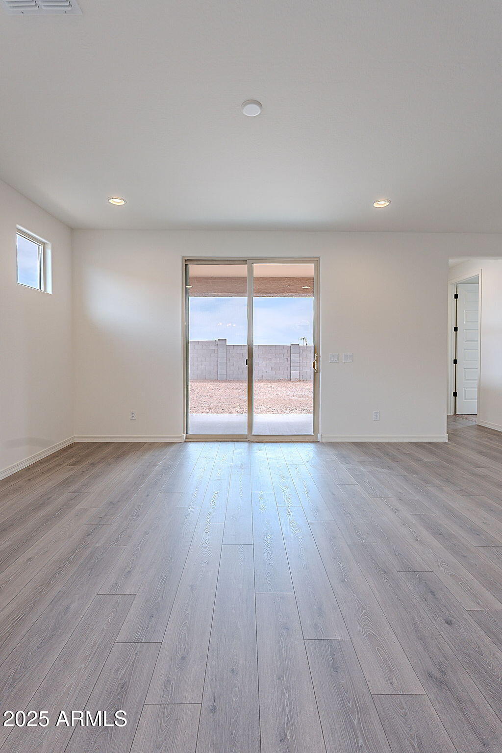 40025 Bunker Drive Maricopa, AZ 85138 - Photo 9 of 18 a view of empty room with wooden floor and fan