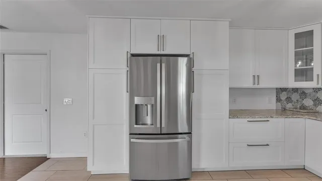 a kitchen with cabinets and stainless steel appliances