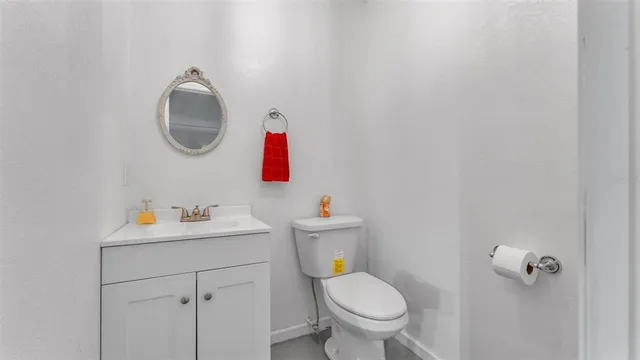 a bathroom with a sink toilet and a mirror
