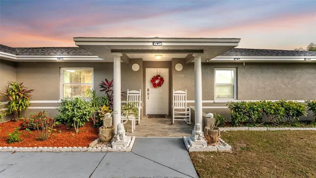 a view of a house with potted plants