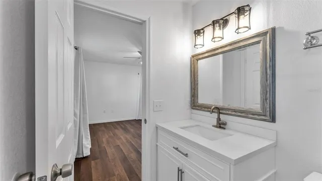 a bathroom with a sink a mirror and vanity
