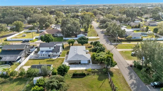 an aerial view of residential houses with outdoor space and swimming pool