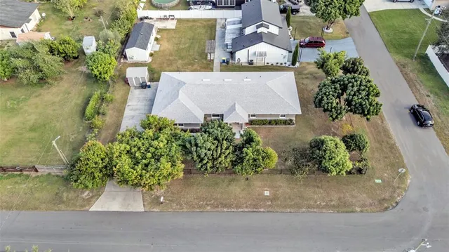 an aerial view of a house with a garden and yard