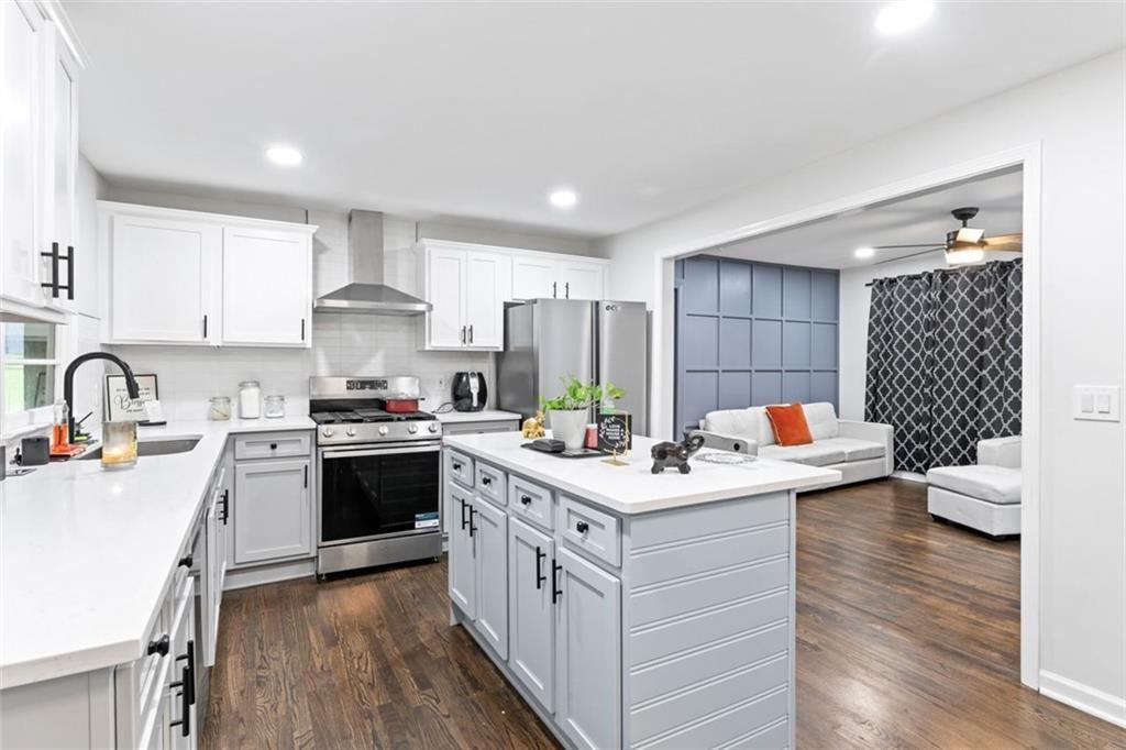 1326 Stella Circle Southwest Mableton, GA 30126 - Photo 11 of 26 a kitchen with a sink stove cabinets and wooden floor