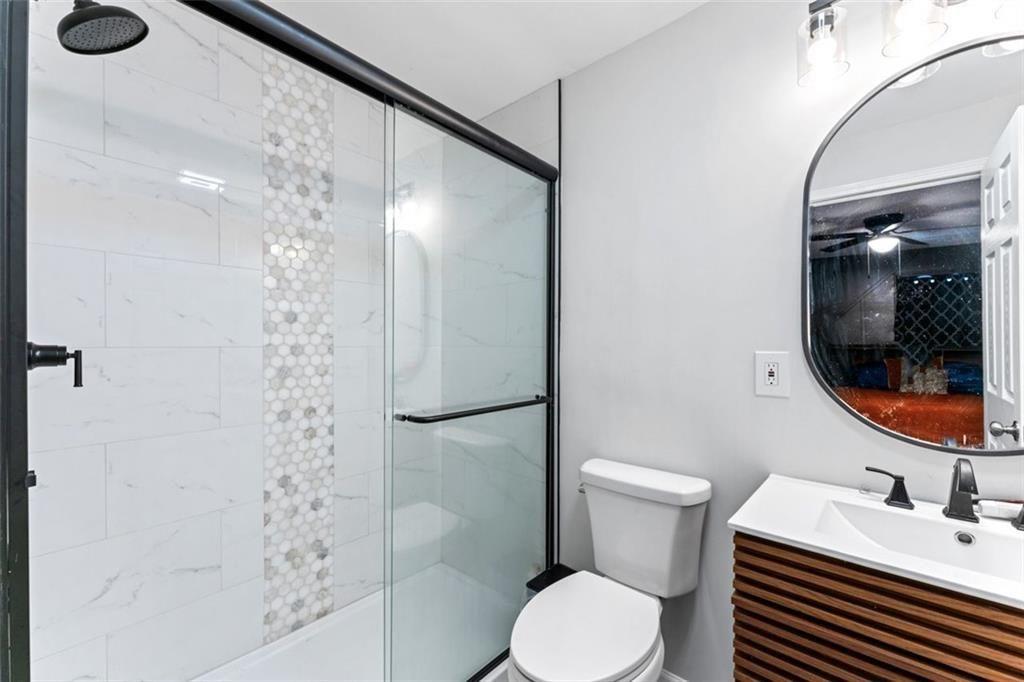 1326 Stella Circle Southwest Mableton, GA 30126 - Photo 20 of 26 a bathroom with a sink a toilet and shower